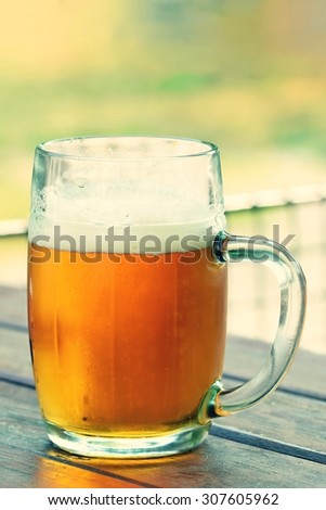Right honest Czech draft beer - a lager in a glass on a wooden background. Glass of beer.