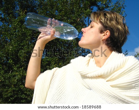 Young woman, drinking soda water from the bottle