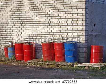Metal fuel barrels, painted red and blue