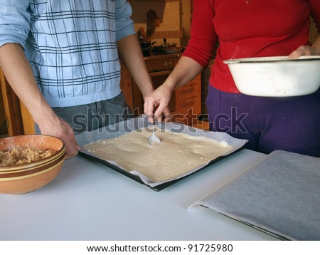 Couple making pie ready for home baking