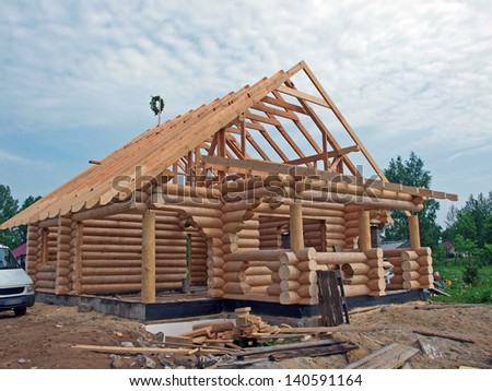 Wooden house from round logs, under construction