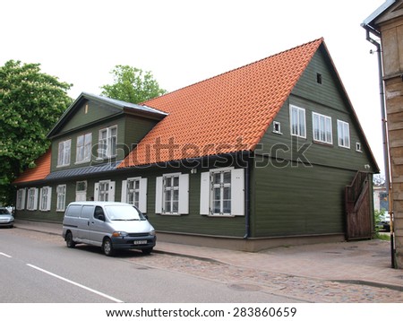 LIEPAJA, LATVIA - JUNE 2, 2015: On street Barinu is restored old historical wooden house with roof of red clay tiles.