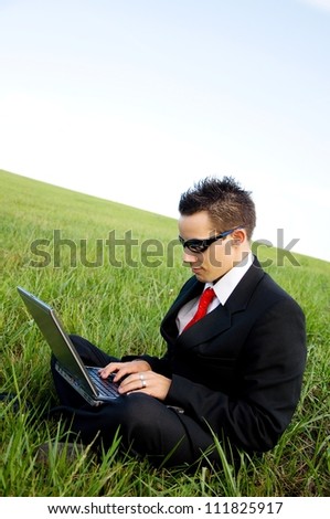 handsome man with laptop over country view