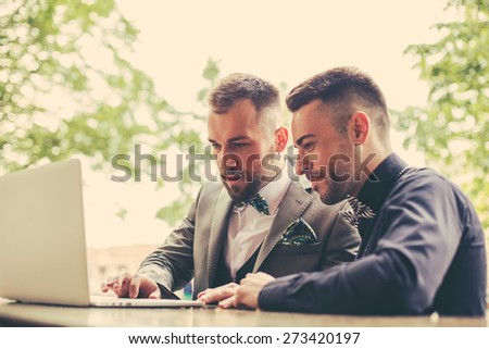 Portrait of two web architects discussing a project in front of a laptop