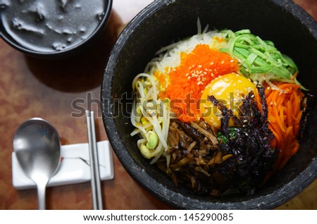 Korean cuisine : bibimbap in a heated stone bowl