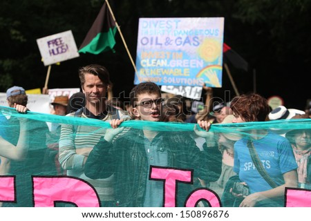 BALCOMBE, UNITED KINGDOM - AUGUST 18: People gather together for an anti-fracking protest march against the energy company Cuadrilla on August 18, 2013 in Balcombe, UK.