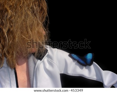 Black and blue veiled butterfly close up on a woman\' shoulder