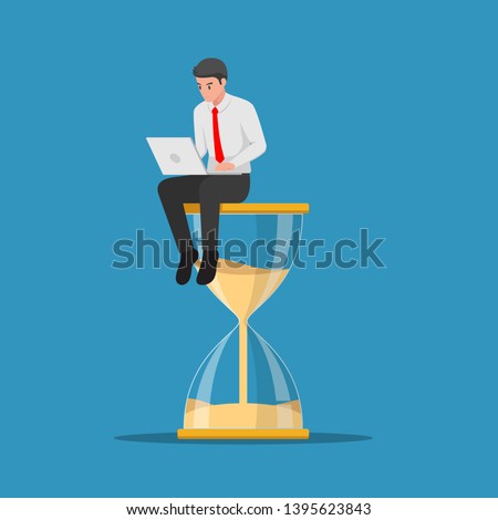 Businessman working with laptop sitting on big hourglass. Time management and deadline concept