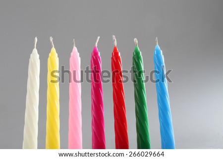 seven birthday candles on neutral background