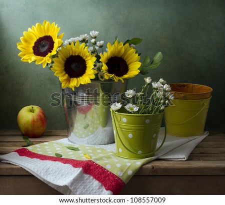 Still life with sunflowers, buckets and apple