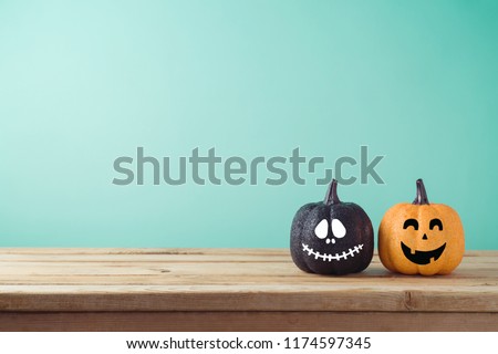 Halloween holiday concept with jack o lantern glitter pumpkin decor on wooden table