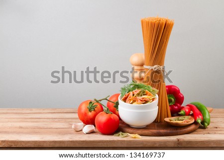 Whole wheat spaghetti and vegetables on wooden tabletop