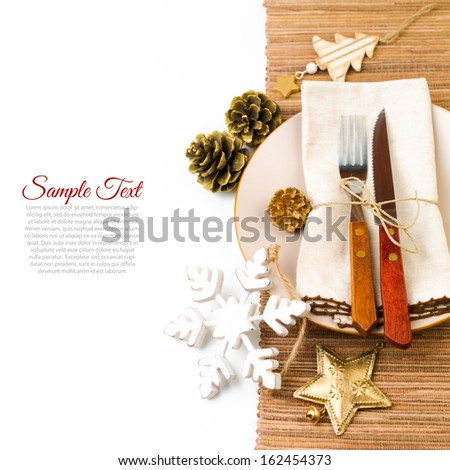 Christmas table setting with plate, kine, fork and decorations