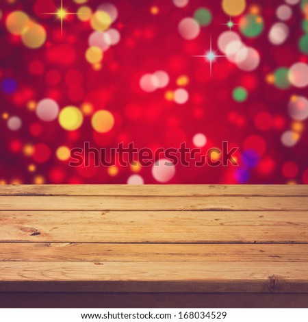 Empty wooden deck table over festive bokeh background. Ready for product montage display