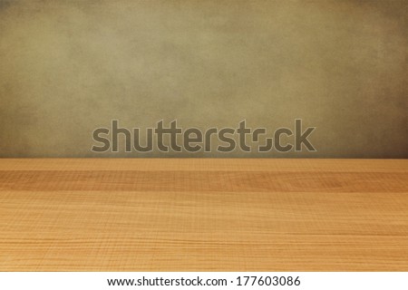 Empty wooden counter over grunge wall