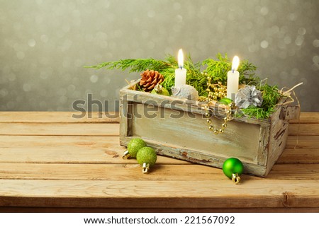 Wooden box with Christmas decorations and candles. Christmas table composition