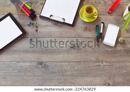 Office desk mock up template with tablet, smart phone and cup of coffee. View from above with copy space