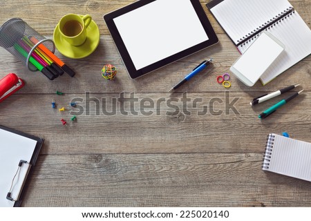 Office desk background with tablet, smart phone and cup of coffee. View from above with copy space