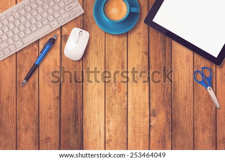 Office desk mock up template with tablet, keyboard and coffee on wooden background