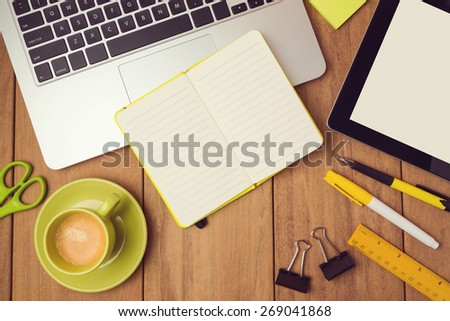 Office desk mock up template with laptop, notebook and tablet. View from above