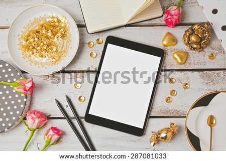 Tablet mock up with feminine objects. View from above