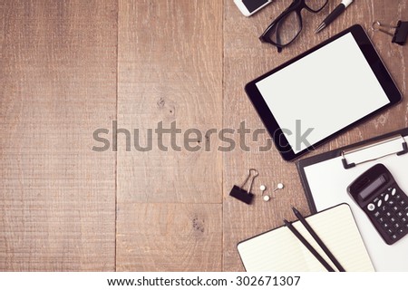 Business background with digital tablet and office items. View from above