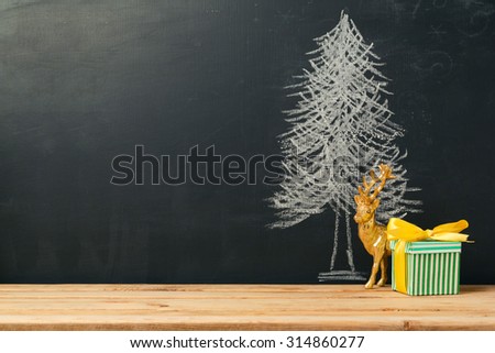 Background with Christmas tree drawing on chalkboard and gift box