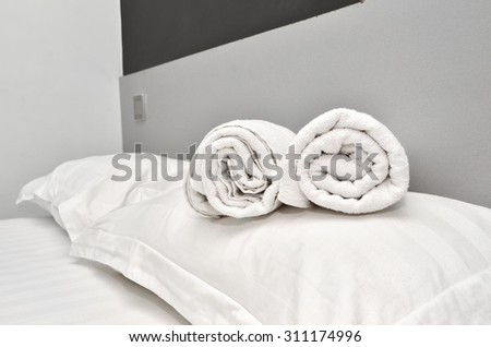 Closeup of soft white towels, rolled and piled