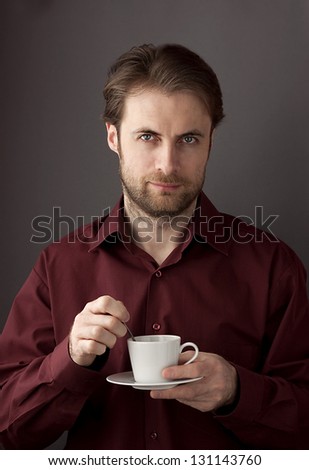 Serious forty years old business man drinking morning coffee