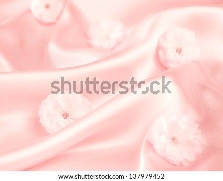 Pink silk fabric background with flowers - soft, elegant, delicate and feminine texture