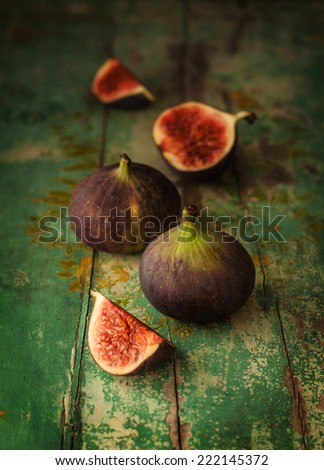 Fresh figs on green vintage wooden table - dark and moody still life