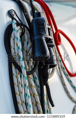 Sail ropes orderly wind up with binoculars.