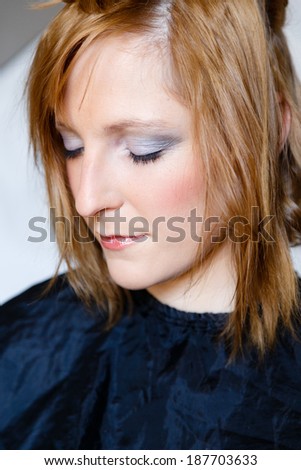 Woman having her hair and make up done for photo shooting