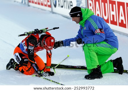 Nove Mesto na Morave, Czech Republic - February 7, 2015. Martin Otcenas gets medical help in finish at the Biathlon World Cup Sprint Men.