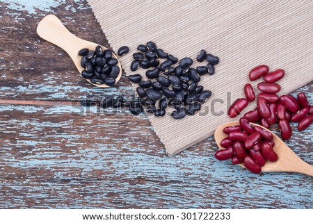 Soy beans, Red beans, black beans, and navy bean on blue wooden background