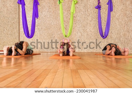 Yoga practicing. Women practicing yoga at health club