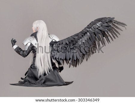 Fantasy woman warrior. Woman warrior with wings and armor isolated on the gray background