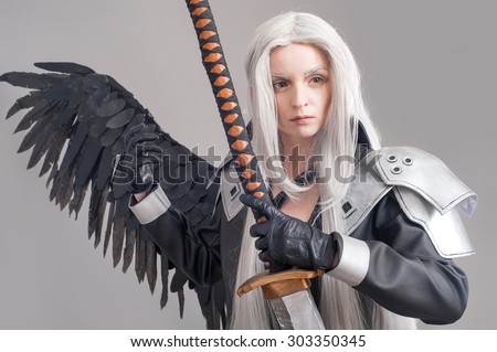 Fantasy woman warrior. Woman warrior with sword and wings isolated on the gray background