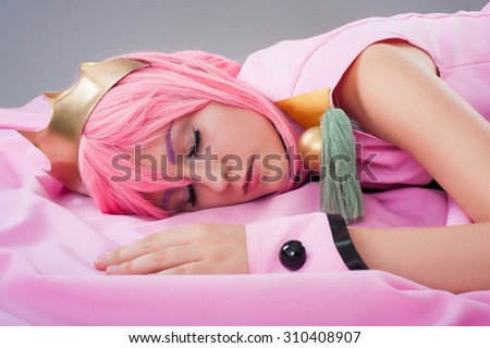 Princess in a pink dress isolated on the gray background