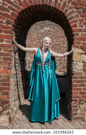 Woman In Medieval Times. Beautiful woman posing on the fortress