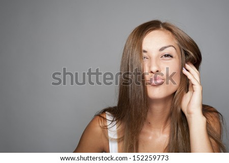 Young beautiful woman crazy expression on white background