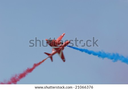 FAIRFORD, UK - JULY 16: RAF Red Arrows solos perform a crossing manuever at the Royal International Air Tattoo on July 16, 2005 in Fairford, UK.