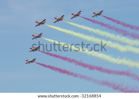 FAIRFORD, UK - JULY 16: Spanish Patrulla Ãguila perform a 8 ship multi color smoke flypast climb during a display at the Royal International Air Tattoo on July 16, 2005 in Fairford, UK.
