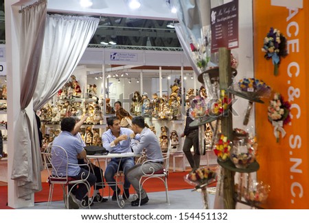 MILAN, ITALY - SEPTEMBER 12: Men talking at a booth in Macef, International Home Show Exhibition on September 12, 2013 in Milan, Italy