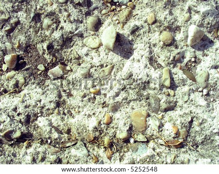 This is a close up of a broken space in a concrete driveway. Would make for a good abstract background texture. Lots of stones, rocks and gravel mixed in everywhere.