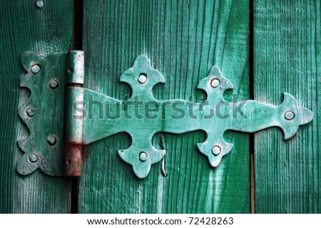 Beautiful ancient door bolt on green collars