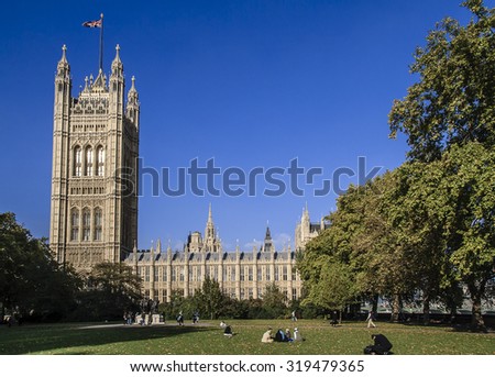 LONDON, UNITED KINGDOM - OCTOBER 23, 2007: View of the side of Parliament in London. People rest on the grass.