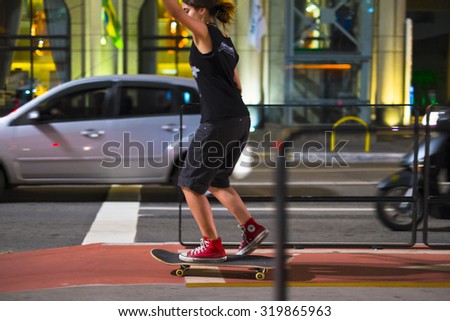 SAO PAULO, BRAZIL - SEPTEMBER 20, 2015:  A girl rides her skate in the new cycle track of the Paulista Avenue that was inaugurated this month. Paulista Avenue is the most famous avenue in the country.