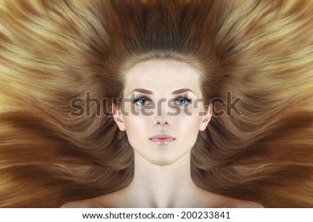 Beautiful woman with long wave blond hairs. Blue eyes. fashion creative studio photoshoot.