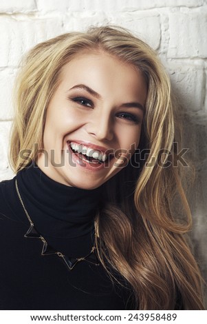 Portrait of happy cheerful smiling young beautiful blond woman. Healthy Long Curly Hair